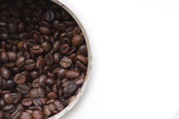 Jar close-up, top view, with roasted coffee beans poured into it. Isolated on white.