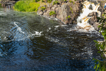 beautiful landscape with cascading waterfall, natural reservoir, river, plants, trees, rocks, mountain in summer in an eco-friendly place Karelia, Russia