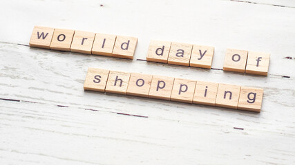 World day of shopping. words from wooden cubes with letters. photo