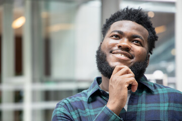 Happy African black man thinking, planning, finding good idea