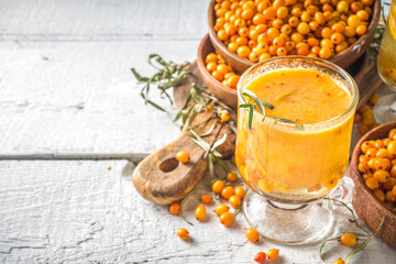 Hot autumn organic drink. Healthy diet beverage, immunity buster food. Sea buckthorn tea with orange and honey in a glass cups. White background copy space