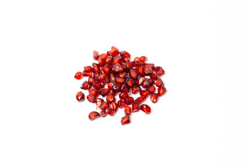 Scattered pomegranate seeds isolated on white background