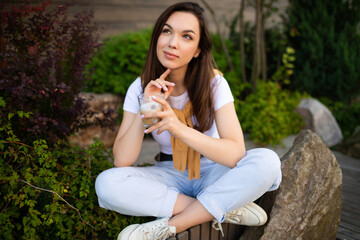 charming young business woman having coffee break sitting on cafe terrace