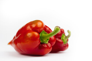 Red and yellow peppers on white background