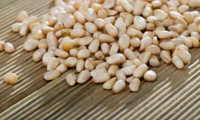 Picture of wooden desk with raw pine nut, no people