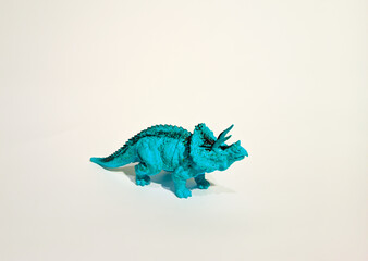 
toy dinosaur, blue triceratops on a white background