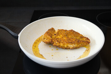 Hähnchenbrust, Schnitzel mit Flohsamenschalen und Chili Panade beim Anbraten