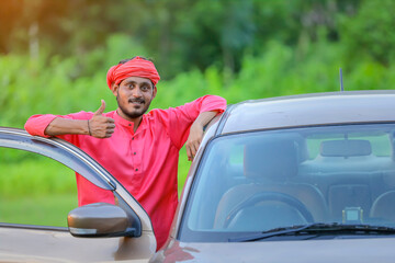 young indian farmer with new car