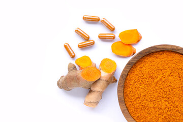 turmeric powder herbal capsules on white.