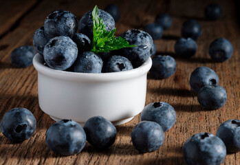 Blueberries with mint leaf in water drops close-up