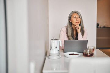 Beautiful woman working on laptop at home