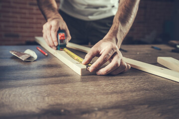 Carpenter measurement on a wooden plank