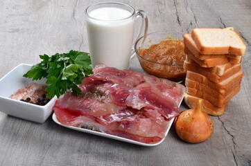 Ingredients for fish cutlets, meatball or fish croquettes. Fresh fish meat, bread, milk, onion, fish caviar and parsley, salt. Copy space