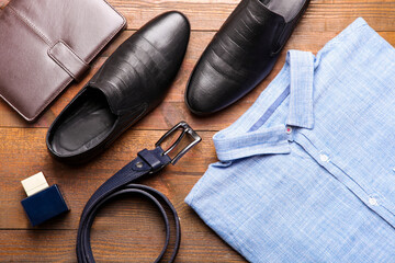 Classic blue men's shirt with black leather shoes and a belt