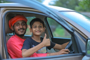 young indian farmer and little child with car