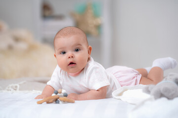 cute baby lying on bed on white blanket against background children's room