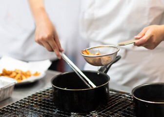 Chef with pans on the stove cooking, Chef preparing food in the kitchen