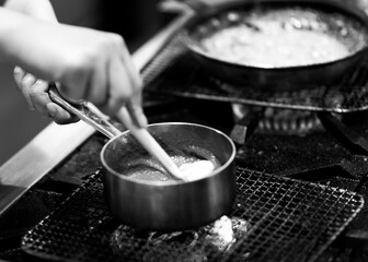 Chef cooking in a kitchen, chef at work, Black & White.