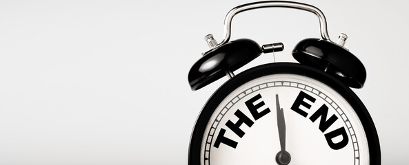 The end wording inside alarm clock with white background and copy space.