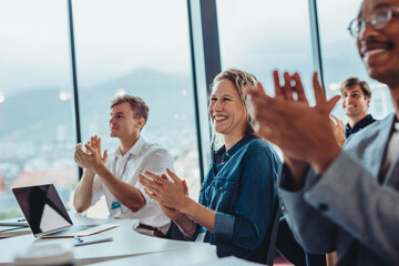 Business professionals clapping hands in conference