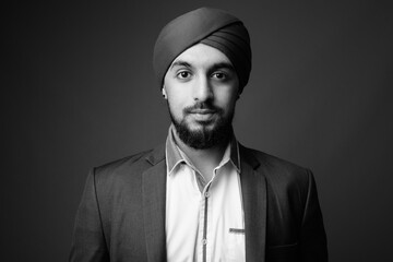 Young bearded Indian Sikh businessman wearing turban