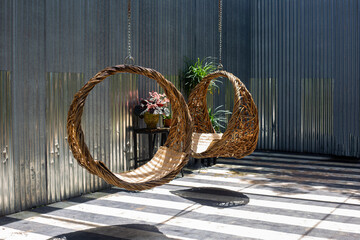 Round modern furniture wood wicker chairs in garden