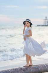 Beautiful women in white dress happily strolling at the beach, beautiful women dressed in white bride