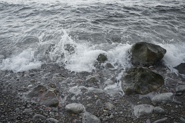 Nice view of the waves crashing against a rock on the beach