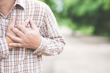 Concept health care .man holding a chest.