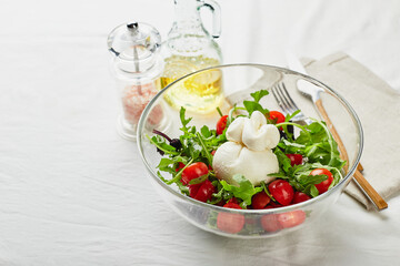 Burrata, Italian fresh cheese made from cream and buffalo or cow milk, with tomato, arugula and red basil salad