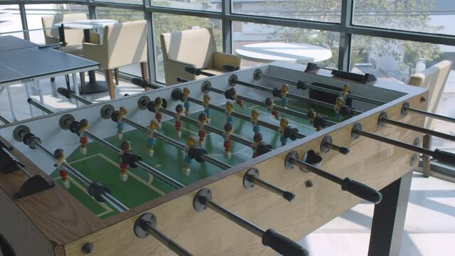 Panning Shot Of An Empty Office Game Room With Table Tennis And Table Football Game