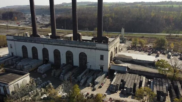 Aerial shot of an old factory along the Mohawk River in Upstate, NY. The property is occupied by a large concrete company.