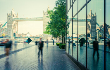 business people, modern buildings and Tower Bridge, London, UK