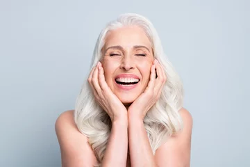 Wanddecoratie Schoonheidssalon Close-up portrait of her she nice attractive excited cheerful grey-haired elderly lady touching cheeks laughing isolated gray pastel color background  © deagreez