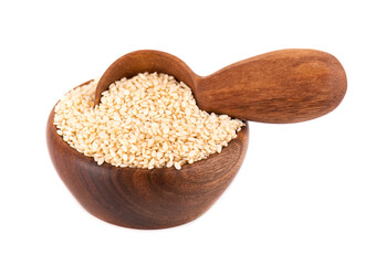 Sesame seeds in wooden bowl and spoon, isolated on white background. Organic dry sesame seeds.
