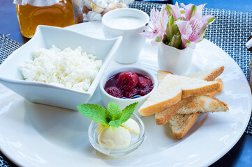 Strawberries with cottage cheese, toast on a plate