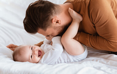 Dad Cuddling Bonding With Cute Little Baby Son At Home