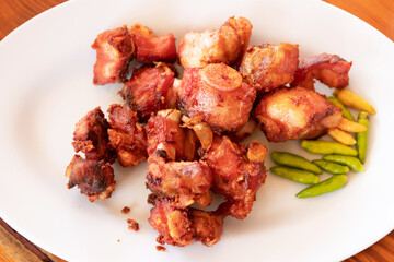 Deep fried pickled pork spare ribs served with sticky rice in Kratip (northern and northeastern Thais as containers for sticky rice).