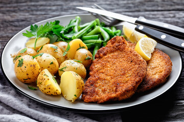 German pork schnitzel with potato and green beans