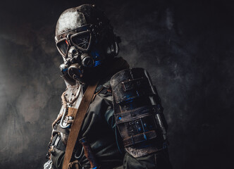 Epidemic and apocalyptic survivor dressed in his custom dark armour and gas mask with broken glass...