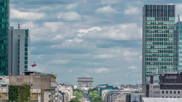 Modern skyscrapers timelapse in famous financial and business district of Paris - La Defense. Cloudy sky at summer day. Arc de triomphe visible on the horizon.