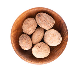 Nutmeg isolated on white background. Dry whole nutmeg in wooden bowl. Close-up. Top view.