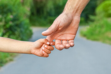 the parent holding the child's hand with a happy background