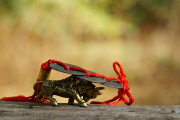 Metal bull figurine with Chinese coins close-up.