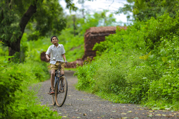 Fototapeta na wymiar indian little boy enjoy cycle riding