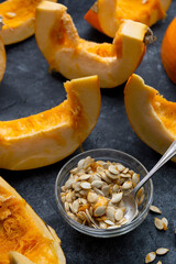 Pumpkin slices isolated on dark background, fall food.