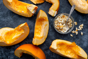 Pumpkin slices isolated on dark background, fall food.