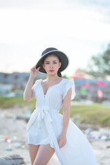 Beautiful women in white dress happily strolling at the beach, beautiful women dressed in white bride