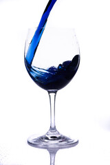 
serving glass with wine. cup with blue liquid.
serving glass.