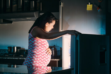 Latin American Pregnant Woman Eating At Night